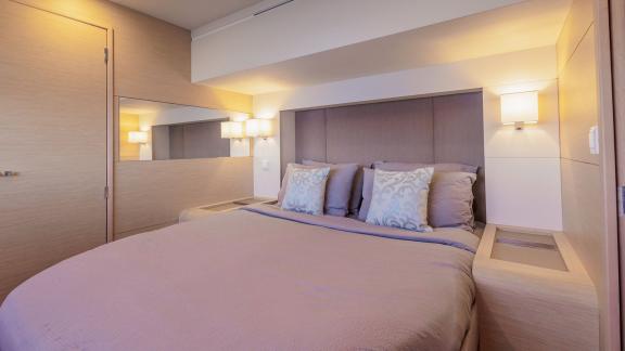 The Ariva features a modern cabin with a large bed, soft lighting and neutral-toned interior.