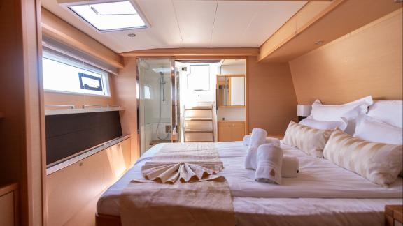 Topaz Lagoon 560 catamaran offers a spacious and cozy master cabin filled with natural light through large windows.
