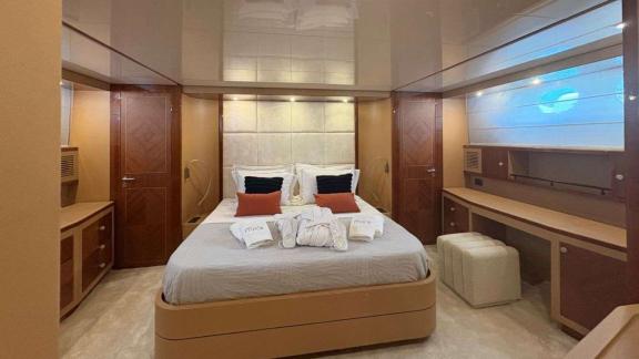Among Athens yacht options master cabin of Mammas motor yacht with double bed and vanity desk.