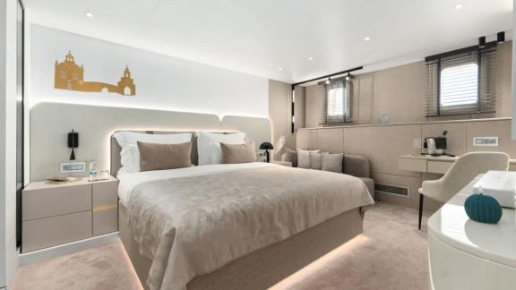 In Split motorsailer charter option Maxita master cabin with large bed and seating area visible.