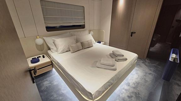 In Sibenik motor yacht charter option First Horizon cabin with double bed and relaxation area visible.