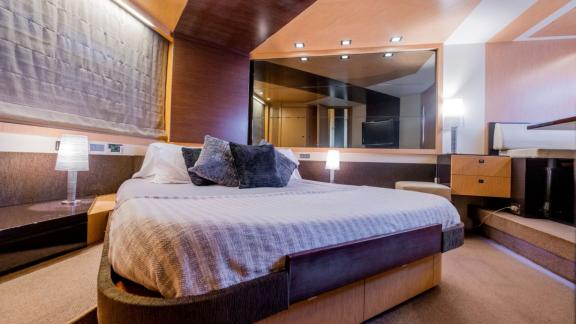 The master cabin of motor yacht Chilli offers a large bed and modern decor for luxurious accommodation.