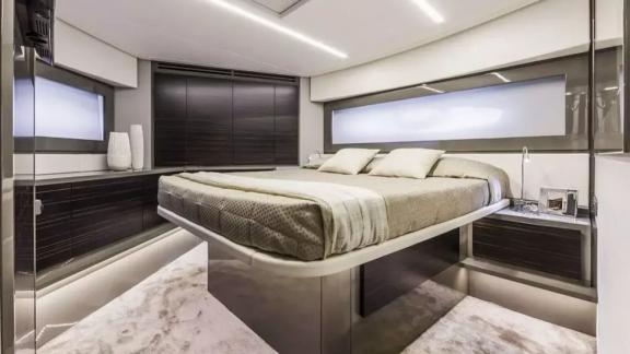 The master cabin of motor yacht Urus features a large bed and modern, luxurious decor.