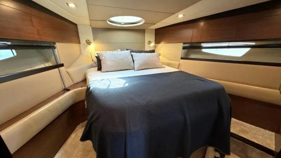 The double cabin on motor yacht Breathe features a spacious bed and modern design for comfort.