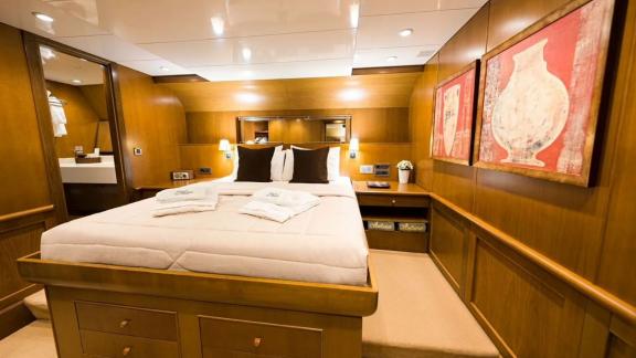 A comfortable and spacious cabin on gulet Arktos, decorated in warm tones.