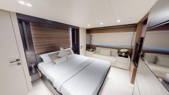 The master bedroom of the Ferretti 670 motor yacht adds elegance and comfort to your luxurious yacht rental experience i