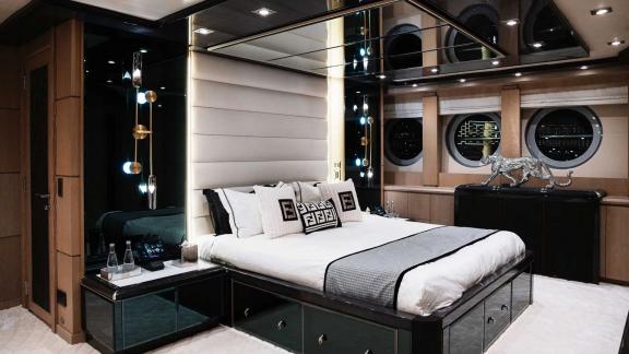 The comfortable bedroom on Ak Royalty yacht offers a unique experience with its sophisticated design.