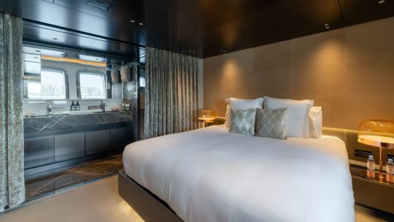 The luxurious master cabin of San Lorenzo Sx88 with a private bathroom elevates your Dubai luxury yacht rental experienc