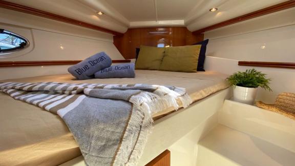 Comfortable bedroom on motor yacht Black Ball, equipped with soft bed linens and decorative details.