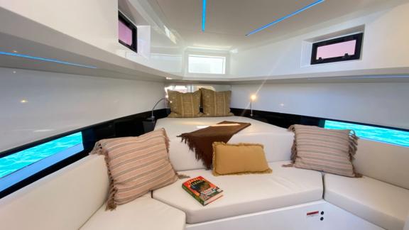 The cozy seating area on motor yacht Ikigai is equipped with cushions and a modern design.