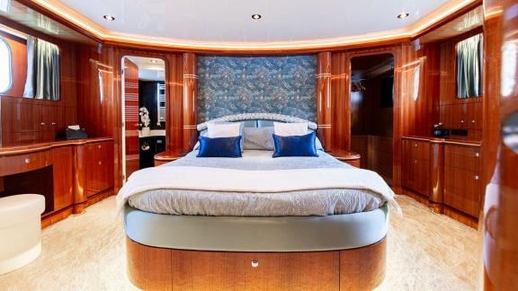 Ehthele’s master cabin features a large bed and elegant wood details while anchored in Mallorca.