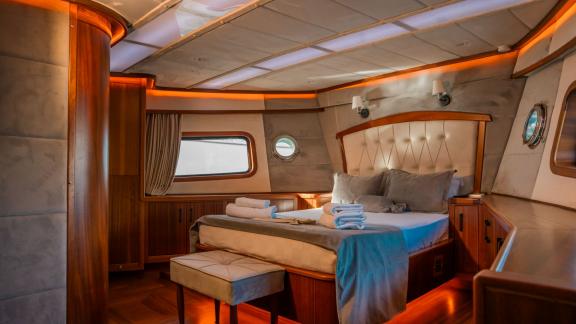 Spacious master cabin with panoramic windows and refined interior details aboard the Oggusto.