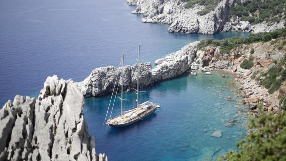 The Silver Moon is anchored in a peaceful, picturesque cove.