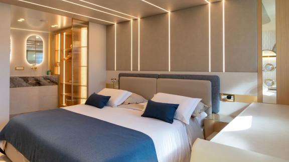 Scorpios Motorsailer features LED wall panels, a spacious bed and a stylish vanity area in this cabin.