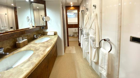 The spacious bathroom on Paula 3 yacht features double sinks and a relaxing ambiance, offering comfort and luxury.