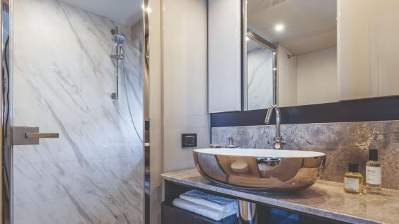 The modern bathroom on Emilia 2 stands out with marble accents and sleek design.