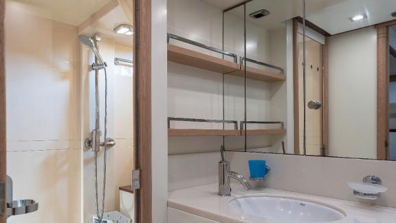 The spacious bathroom of motor yacht Vida Boa features a modern sink and a large shower area with stylish design.