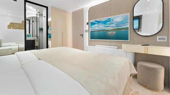 In Split motorsailer charter option Maxita cabin with double bed and vanity desk visible.