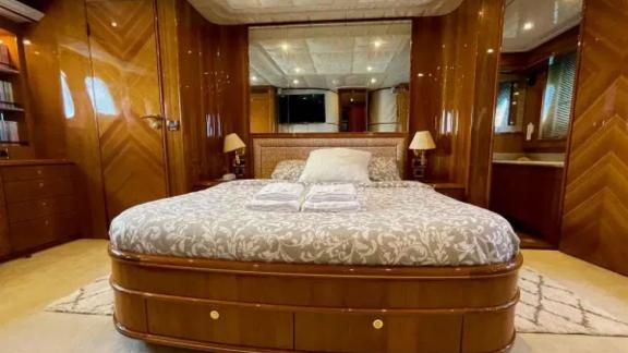 The master cabin of motor yacht Riva 21 features a large bed and elegant decor for maximum comfort.