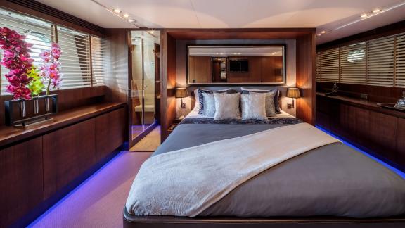 The master cabin on yacht Miraval features a comfortable bed and elegant decor.