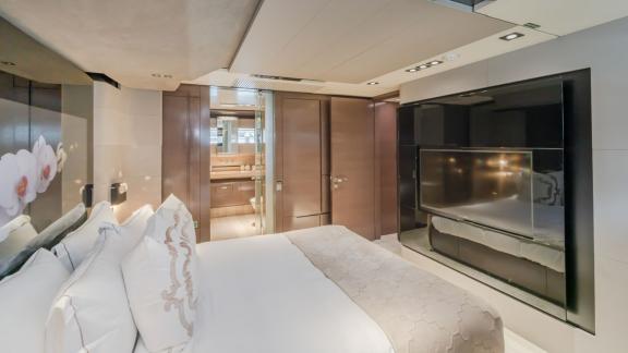 The bedroom of the Saffuriya yacht features a modern TV unit and a comfortable design.