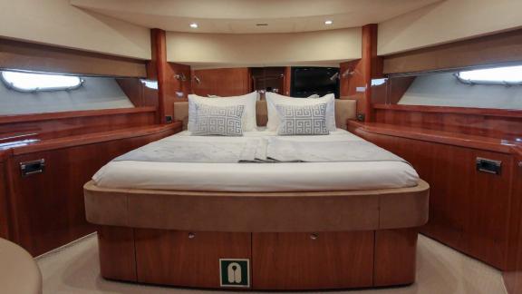 This stylish bedroom on the Notorious motor yacht makes your Dubai yacht rental experience luxurious and cozy.