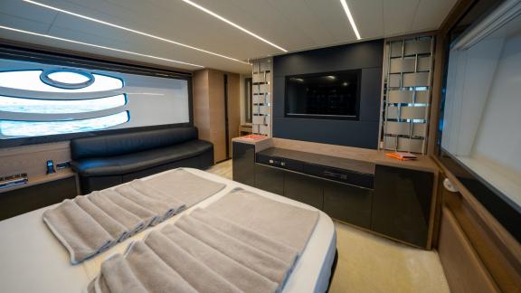 Enjoy a luxurious living space in the master cabin of Pershing 70 with your Dubai motor yacht rental.