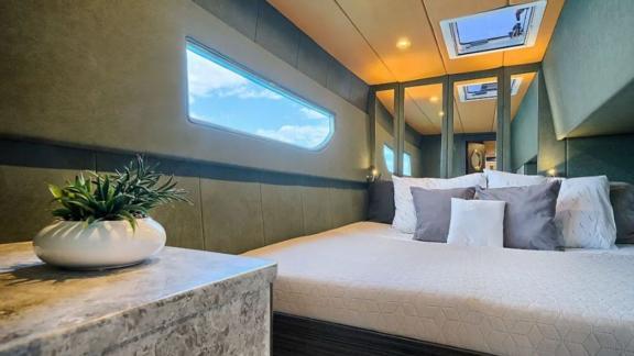 This stylish cabin features sea view window, ceiling hatch and elegant design for a relaxing yacht stay.