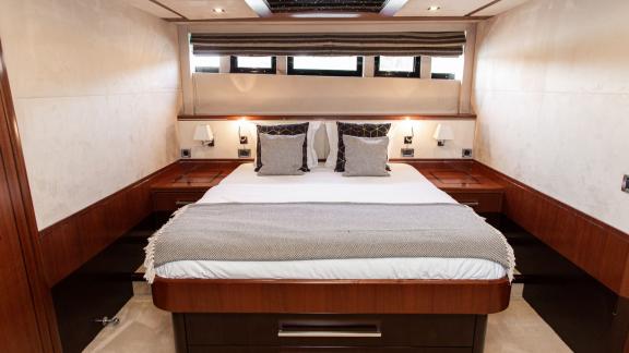 Comfortable master cabin with wide windows aboard Le Chiffre in Šibenik.