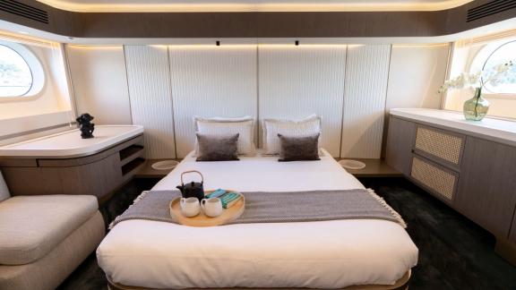 Comfortable sleeping space with elegant design and large windows.
