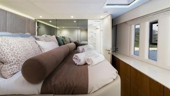 In Kastela Zara’s cabin includes sea view windows soft bedding and private bathroom access.