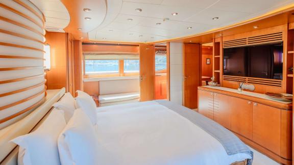 Ariela’s master cabin features a king bed, TV unit and seating by the window with Göcek views.