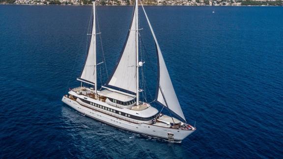 The elegant Omnia sailboat glides majestically over the clear blue waters off the coast of Split.