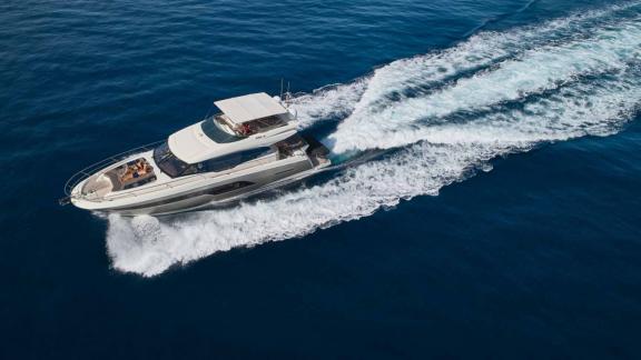 The motor yacht Simull cruising at high speed through the blue waters of Croatia.