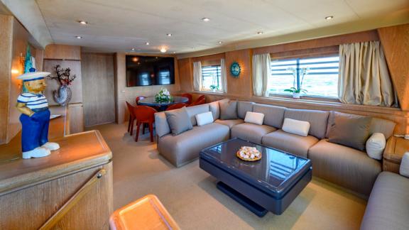 Experience luxury and comfort in the spacious lounge of Sandi IV with an Italy motor yacht rental.