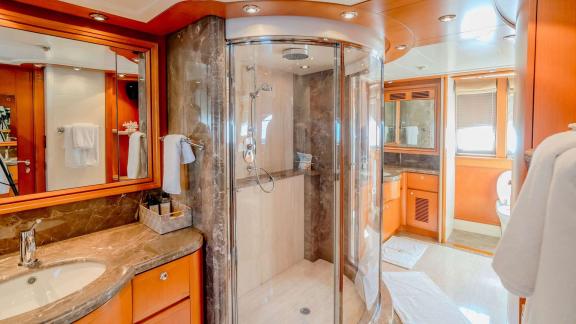 Ariela’s ensuite features a spacious shower, twin sinks and elegant wood-marble design details.