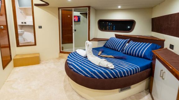 The master cabin on motor yacht Selenge offers modern accommodations with a comfortable bed and stylish decor.