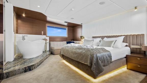 Spacious suite with king-size bed and luxurious bathtub.