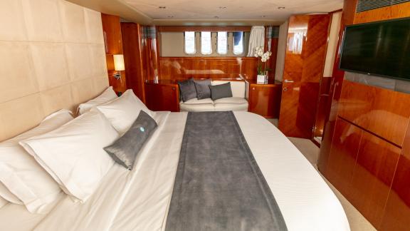 The spacious bedroom of the yacht Azure offers a comfortable bed and modern decor for a cozy atmosphere.