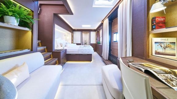 Luxurious suite with double bed, sofa, and workspace on Lagoon Seventy 7.