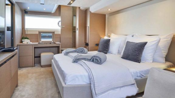 Spacious bedroom and vanity desk of motor yacht Simull.