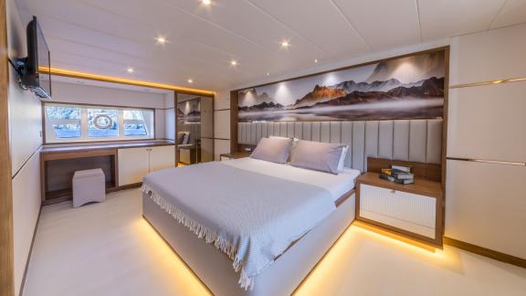 Elegant double cabin on the Floki trawler yacht with modern decor and a large window.