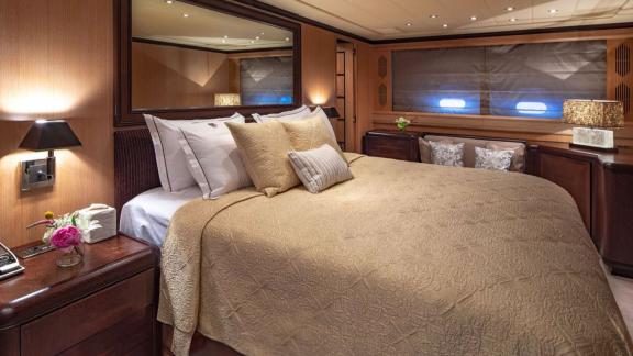 Cosmos yacht’s stylish guest cabin pairs warm tones with peaceful sea views and comfort.