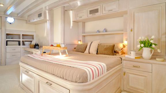 The master cabin of White Pearl gulet in Athens offers a large double bed and storage units.