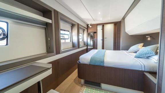 Large cabin with a double bed, desk, and modern design on the Bali Catamaran Signature Concept.