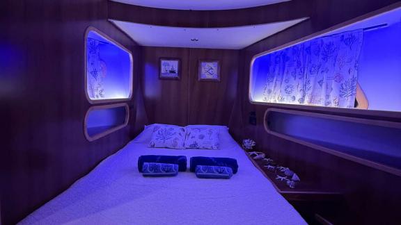 Cozy cabin with blue lighting and sea-themed decor on Barbaros 3 yacht.