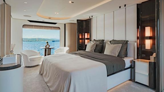 Modern bedroom with sea view, furnished with bright and stylish design.