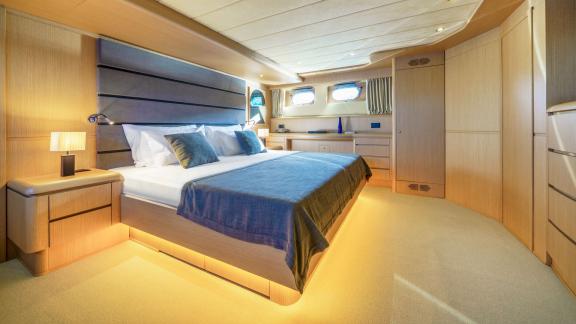 The master cabin aboard Phantom yacht impresses with elegance and roominess.