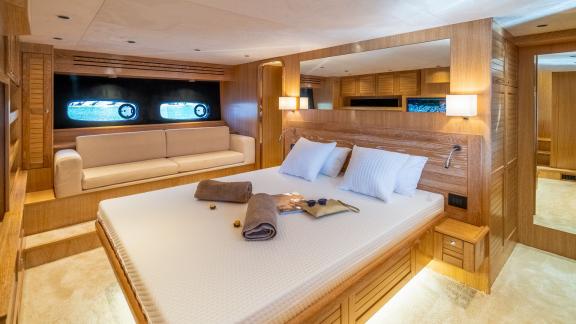 The master cabin on Cloud 9 blends natural wood tones with cozy seating, creating a warm and luxurious atmosphere.