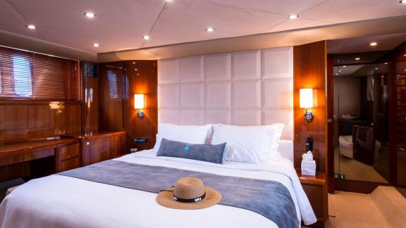 The bedroom of the yacht Azure offers a comfortable bed and elegant decor for a cozy stay.